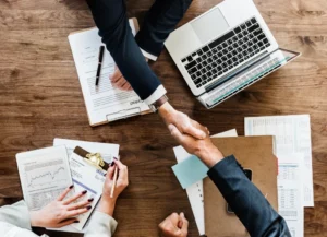 business people shaking hands together